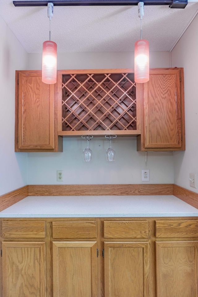 7639 Nicholas Way, Chanhassen, MN 55317 - kitchen featuring light countertops, pendant lighting, a textured ceiling, and light brown cabinets
