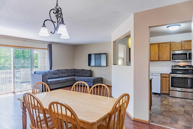 7639 Nicholas Way, Chanhassen, MN 55317 - dining room featuring a chandelier and a textured ceiling