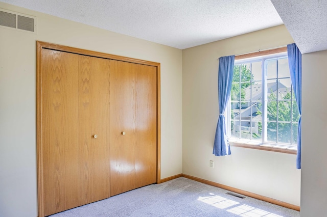 7639 Nicholas Way, Chanhassen, MN 55317 - unfurnished bedroom featuring carpet floors, a textured ceiling, and a closet