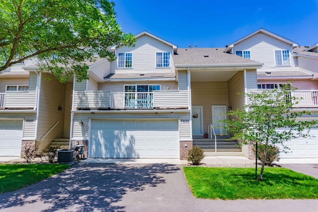 7639 Nicholas Way, Chanhassen, MN 55317 - townhome / multi-family property with asphalt driveway, an attached garage, a balcony, and roof with shingles