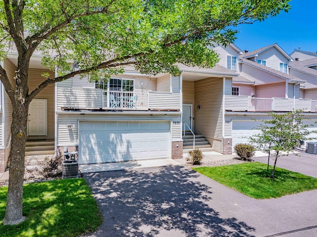7639 Nicholas Way, Chanhassen, MN 55317 - view of front of property featuring a garage, a balcony, and asphalt driveway