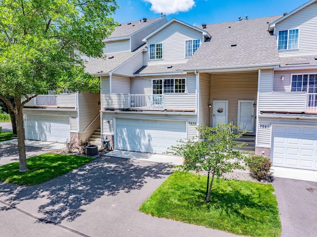 7639 Nicholas Way, Chanhassen, MN 55317 - townhome / multi-family property featuring driveway, a shingled roof, a garage, and a balcony