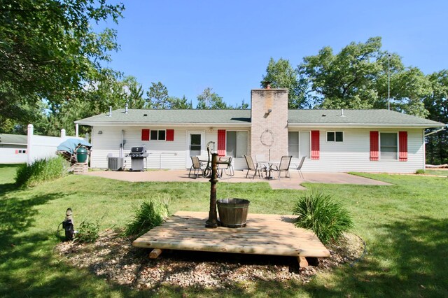 11715 Sorenson Lake Rd, Merrifield, MN 56465 - rear view of house featuring a chimney, a patio, and a lawn