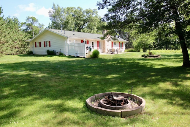 11715 Sorenson Lake Rd, Merrifield, MN 56465 - rear view of house with an outdoor fire pit, a patio, a chimney, and a lawn