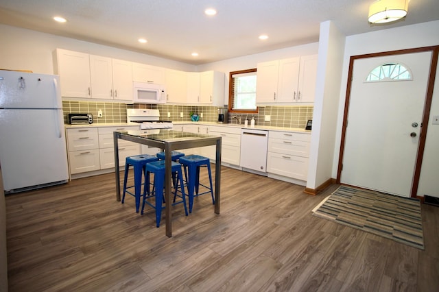 11715 Sorenson Lake Rd, Merrifield, MN 56465 - kitchen featuring white appliances, dark wood finished floors, white cabinets, tasteful backsplash, and recessed lighting