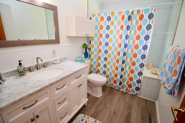 11715 Sorenson Lake Rd, Merrifield, MN 56465 - full bathroom with vanity, wood finished floors, a wainscoted wall, and shower / bathtub combination with curtain