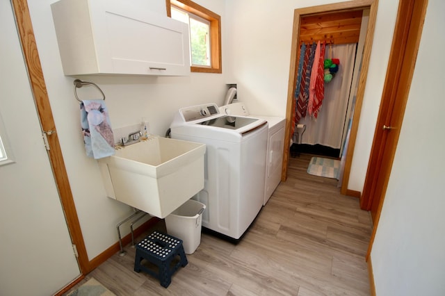 11715 Sorenson Lake Rd, Merrifield, MN 56465 - washroom featuring washing machine and dryer, cabinet space, and light wood finished floors