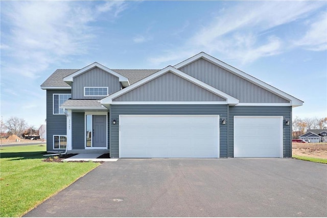 37569 Greenwich Ct, North Branch, MN 55056 - view of front of home with driveway, an attached garage, a front lawn, and a shingled roof