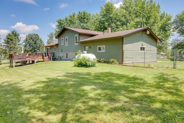 7771 Odean Ave NE, Otsego, MN 55330 - back of house with a wooden deck, a chimney, and a shingled roof