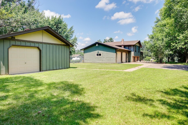 7771 Odean Ave NE, Otsego, MN 55330 - view of front facade featuring board and batten siding, an outbuilding, a detached garage, and a front lawn