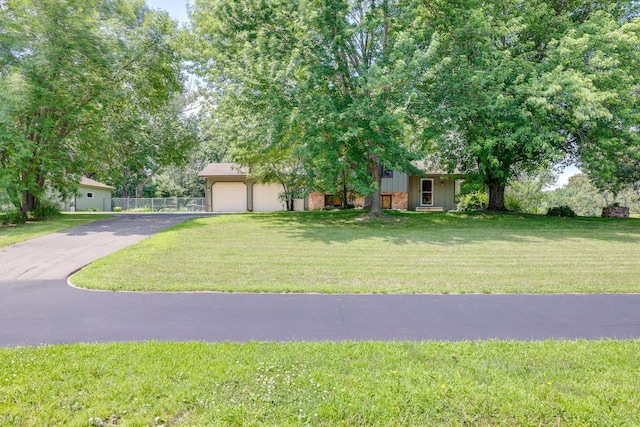 7771 Odean Ave NE, Otsego, MN 55330 - view of property hidden behind natural elements featuring driveway, an attached garage, board and batten siding, and brick siding