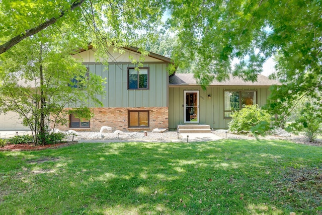 7771 Odean Ave NE, Otsego, MN 55330 - split level home featuring board and batten siding, brick siding, a front yard, and roof with shingles