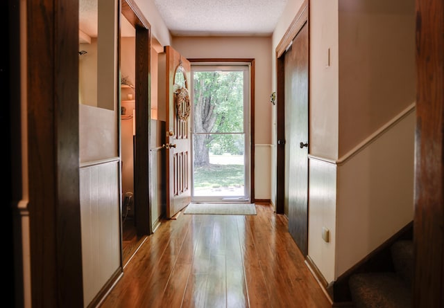 7771 Odean Ave NE, Otsego, MN 55330 - doorway featuring hardwood / wood-style floors, a textured ceiling, and stairway