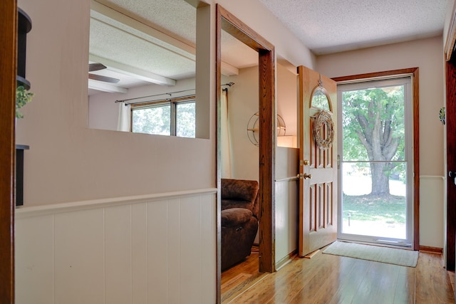 7771 Odean Ave NE, Otsego, MN 55330 - foyer with a textured ceiling, wood finished floors, wainscoting, ceiling fan, and beamed ceiling