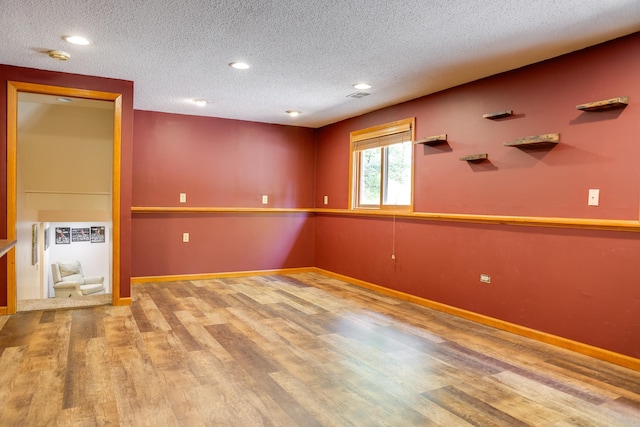 7771 Odean Ave NE, Otsego, MN 55330 - spare room with wood finished floors, a textured ceiling, recessed lighting, and a smoke detector