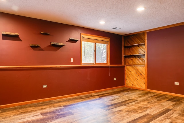 7771 Odean Ave NE, Otsego, MN 55330 - empty room featuring a textured ceiling, wood finished floors, and recessed lighting