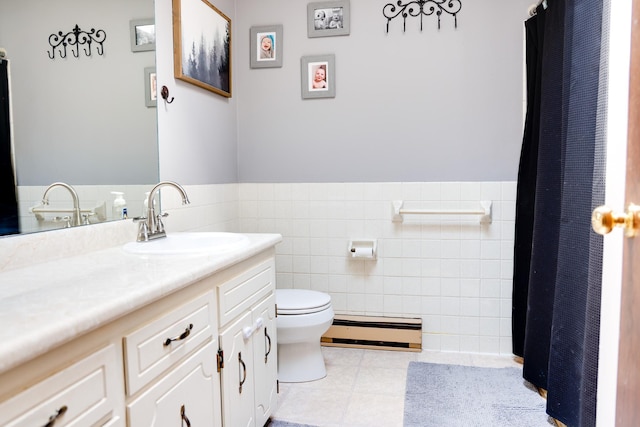 7771 Odean Ave NE, Otsego, MN 55330 - bathroom featuring baseboard heating, vanity, tile walls, a wainscoted wall, and tile patterned floors