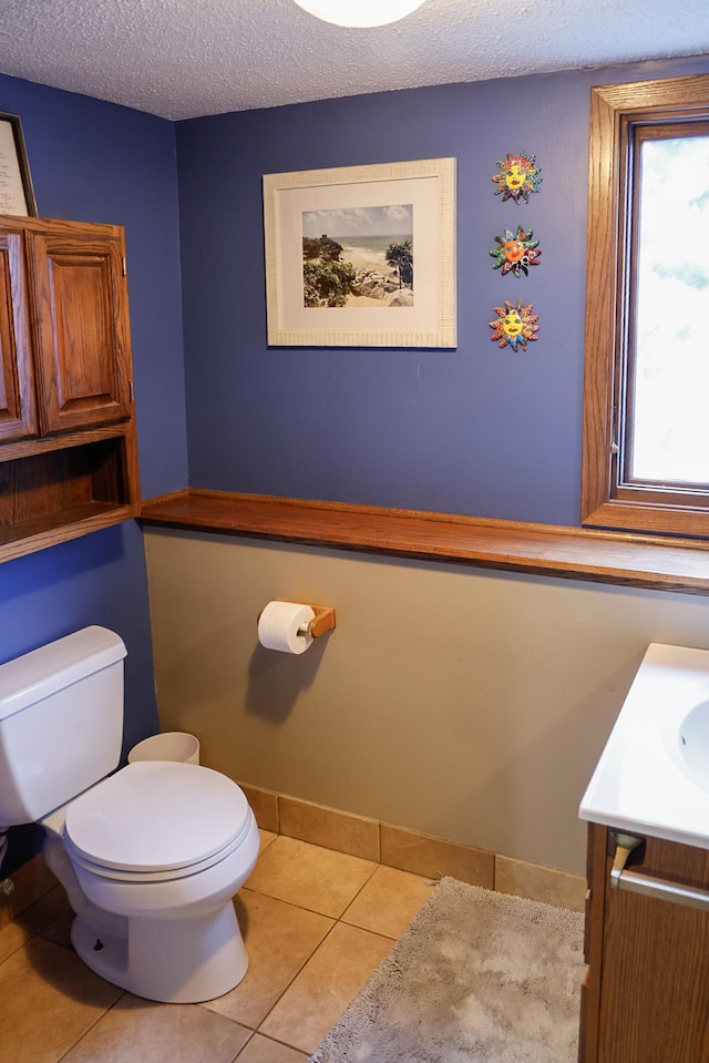 7771 Odean Ave NE, Otsego, MN 55330 - half bath with vanity, a textured ceiling, and tile patterned flooring