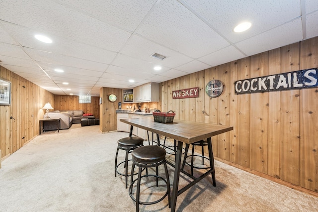 1073 Allen Ave W, Saint Paul, MN 55118 - dining area featuring light carpet, wood walls, and a drop ceiling