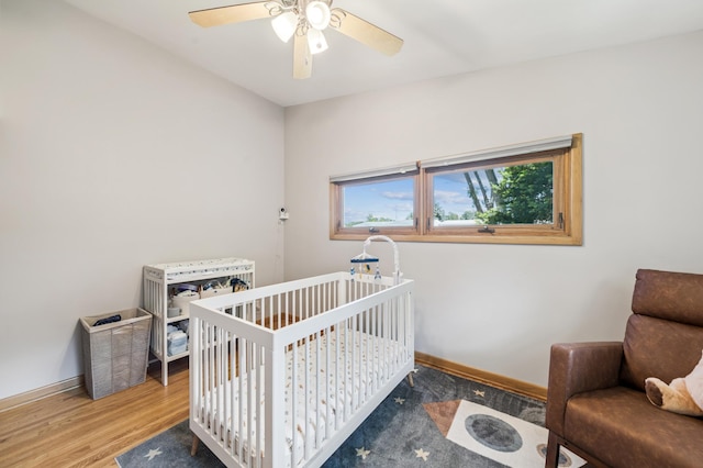 1073 Allen Ave W, Saint Paul, MN 55118 - bedroom featuring wood finished floors, a ceiling fan, and a crib