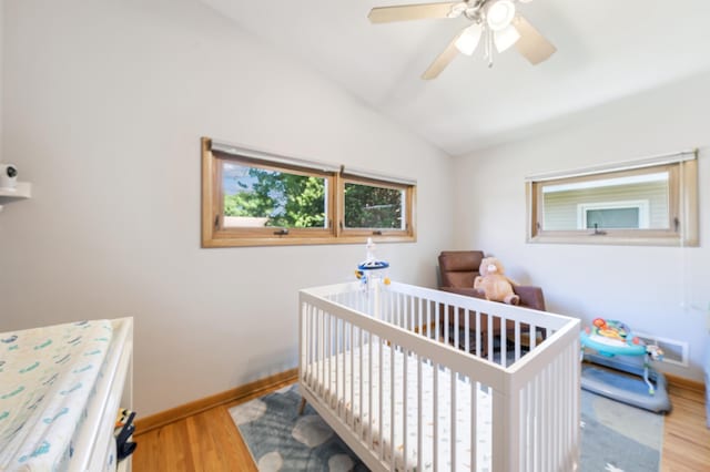 1073 Allen Ave W, Saint Paul, MN 55118 - bedroom with wood finished floors, vaulted ceiling, a crib, and ceiling fan