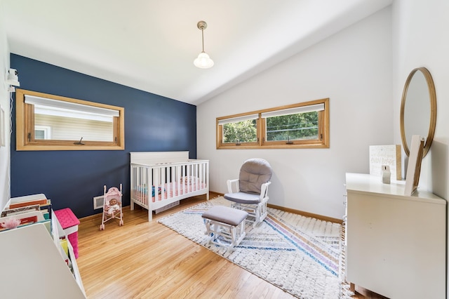 1073 Allen Ave W, Saint Paul, MN 55118 - bedroom with lofted ceiling, wood finished floors, and a nursery area