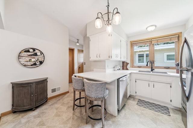 1073 Allen Ave W, Saint Paul, MN 55118 - kitchen featuring appliances with stainless steel finishes, white cabinets, light countertops, a peninsula, and a kitchen breakfast bar