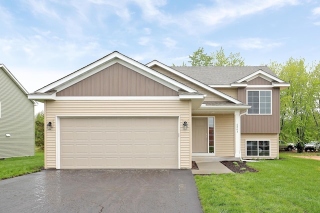 37554 Greenwich Ct, North Branch, MN 55056 - view of front of house featuring a front yard, asphalt driveway, a shingled roof, and an attached garage