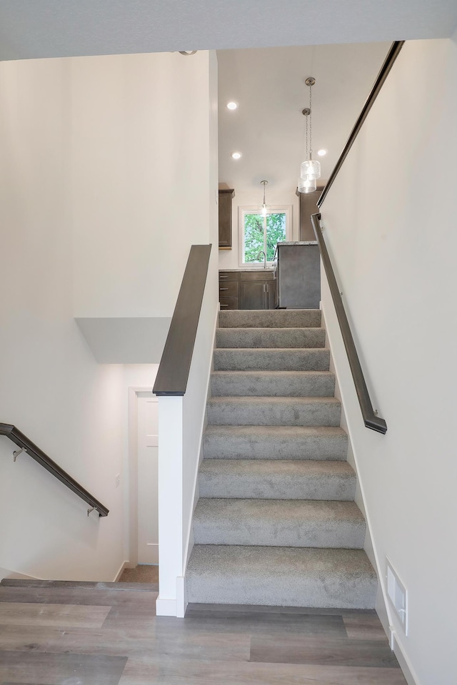 37554 Greenwich Ct, North Branch, MN 55056 - stairway with wood finished floors and recessed lighting