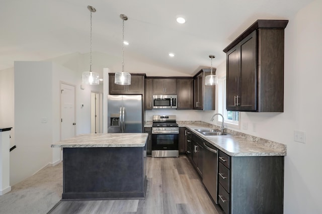 37554 Greenwich Ct, North Branch, MN 55056 - kitchen with stainless steel appliances, dark brown cabinetry, a kitchen island, light countertops, and light wood-style floors