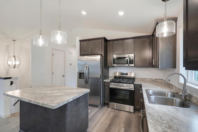37554 Greenwich Ct, North Branch, MN 55056 - kitchen featuring stainless steel appliances, lofted ceiling, dark brown cabinetry, light countertops, and pendant lighting