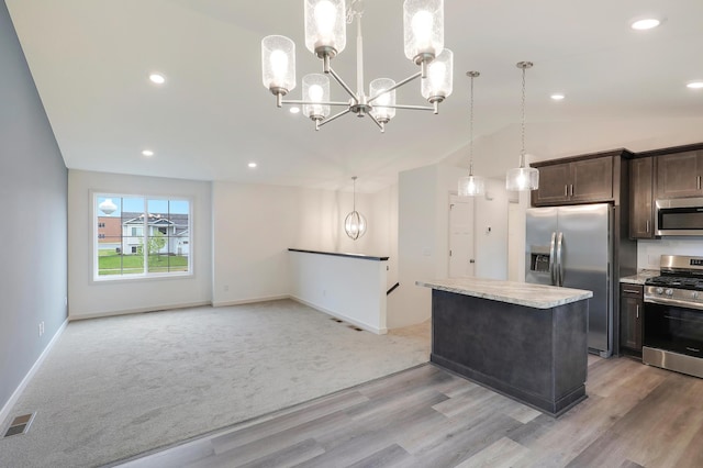37554 Greenwich Ct, North Branch, MN 55056 - kitchen with stainless steel appliances, a chandelier, dark brown cabinetry, a kitchen island, and lofted ceiling