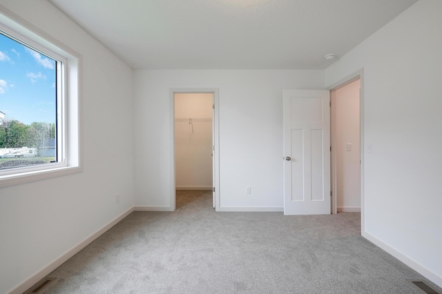37554 Greenwich Ct, North Branch, MN 55056 - unfurnished bedroom with carpet flooring and a walk in closet