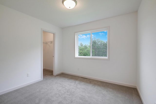 37554 Greenwich Ct, North Branch, MN 55056 - unfurnished bedroom featuring carpet and a walk in closet