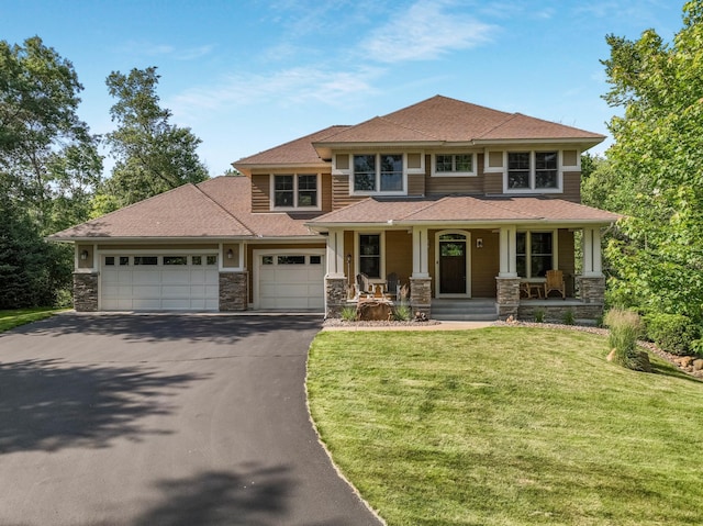 860 Prairie Meadows Dr, Hudson, WI 54016 - view of front of property featuring stone siding, driveway, a garage, a front yard, and a porch