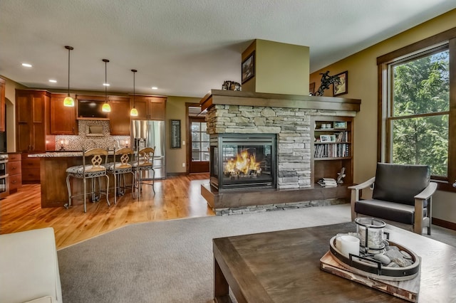 860 Prairie Meadows Dr, Hudson, WI 54016 - living room featuring light wood finished floors, a fireplace, and recessed lighting