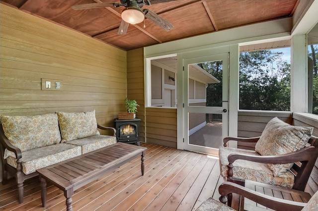 860 Prairie Meadows Dr, Hudson, WI 54016 - sunroom / solarium featuring a ceiling fan, plenty of natural light, and a wood stove
