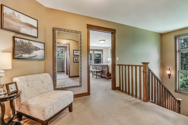 860 Prairie Meadows Dr, Hudson, WI 54016 - living area featuring carpet flooring, an upstairs landing, and arched walkways