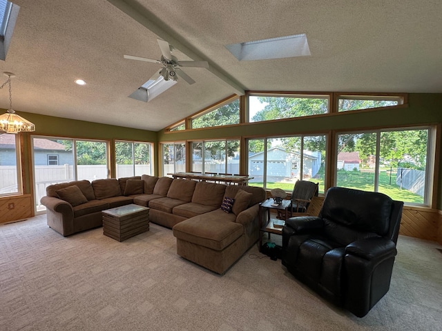 121 Park St, Luverne, MN 56156 - carpeted living room with a skylight, a textured ceiling, plenty of natural light, ceiling fan, and a chandelier