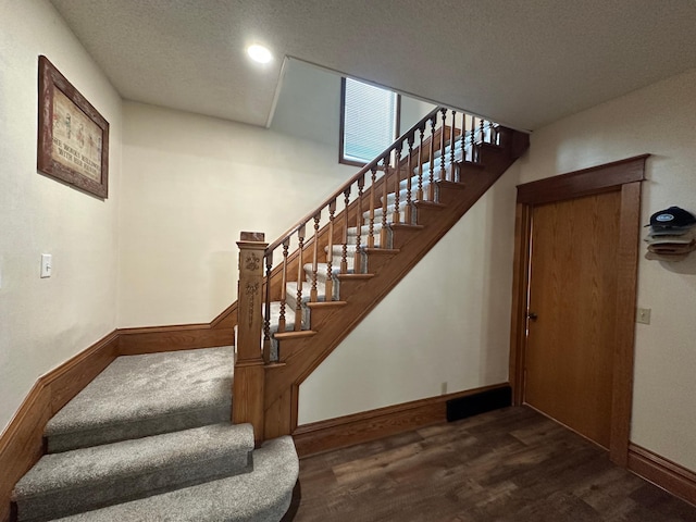 121 Park St, Luverne, MN 56156 - staircase featuring wood finished floors and a textured ceiling