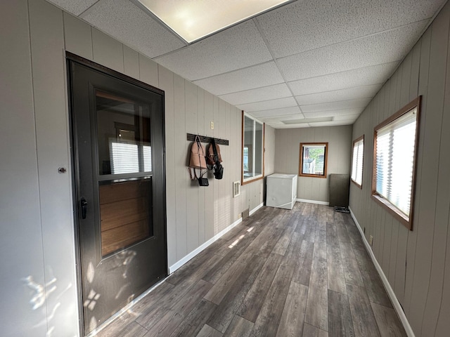 121 Park St, Luverne, MN 56156 - unfurnished room with a paneled ceiling, dark wood finished floors, and wood walls