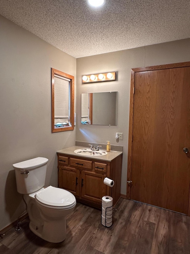 121 Park St, Luverne, MN 56156 - half bathroom with wood finished floors, a textured ceiling, and vanity