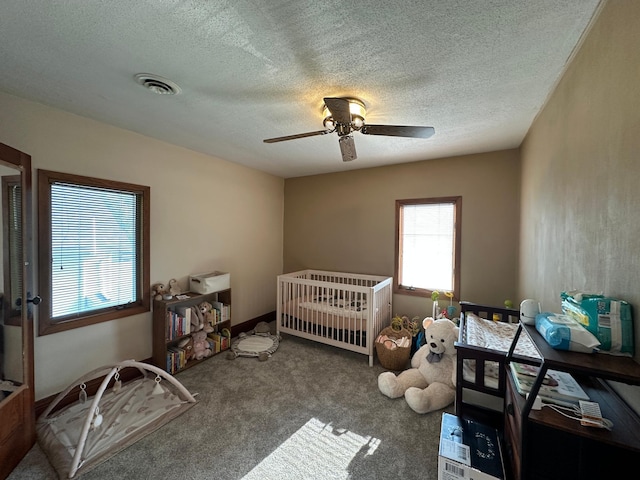 121 Park St, Luverne, MN 56156 - carpeted bedroom featuring a textured ceiling and a ceiling fan