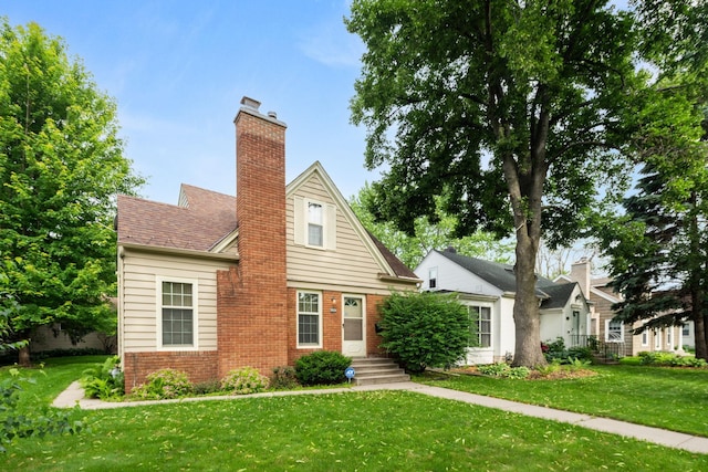 5924 10th Ave S, Minneapolis, MN 55417 - view of front of property with brick siding, a front yard, and a chimney