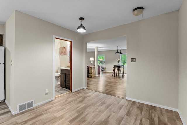 27900 Old Towne Rd, Chisago City, MN 55013 - unfurnished dining area with light wood-style floors and baseboards
