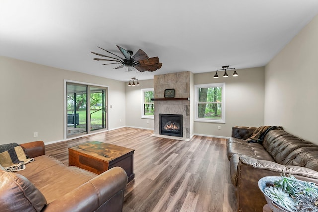 27900 Old Towne Rd, Chisago City, MN 55013 - living area featuring wood finished floors, a fireplace, and ceiling fan