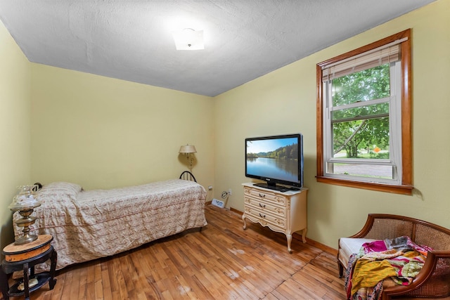 27900 Old Towne Rd, Chisago City, MN 55013 - bedroom featuring hardwood / wood-style flooring and a textured ceiling