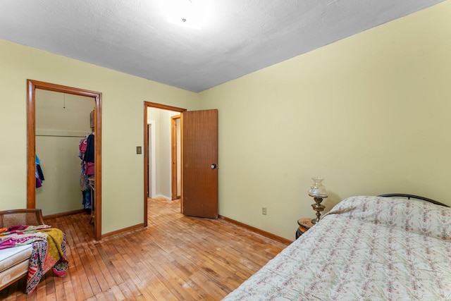 27900 Old Towne Rd, Chisago City, MN 55013 - bedroom featuring light wood-style flooring, a spacious closet, and a closet