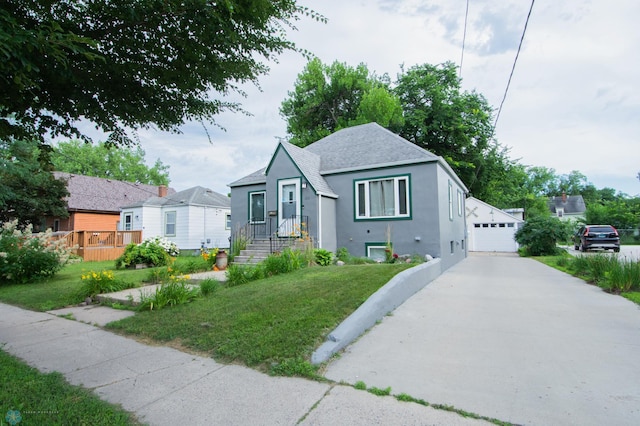 1514 1st Ave S, Fargo, ND 58103 - bungalow-style house featuring stucco siding, roof with shingles, a front lawn, and a detached garage