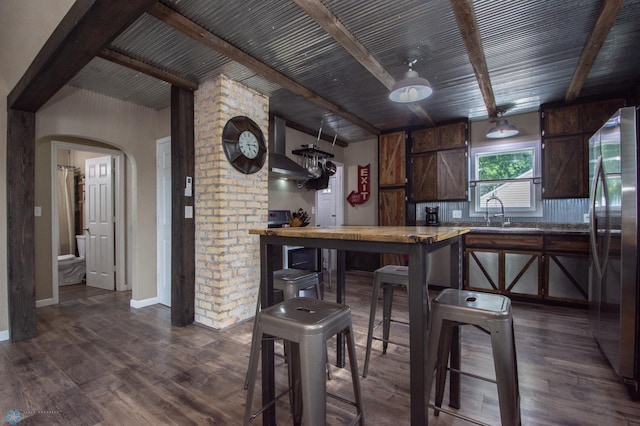 1514 1st Ave S, Fargo, ND 58103 - kitchen with freestanding refrigerator, beam ceiling, dark wood finished floors, dark brown cabinets, and arched walkways